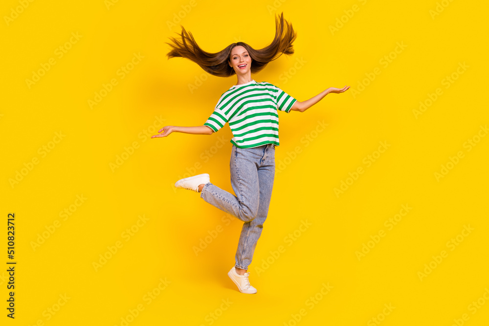 Full length portrait of pretty cheerful lady hands throw flying hairdo isolated on yellow color background