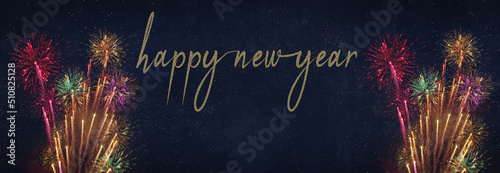 HAPPY NEW YEAR - New Year's Eve, Silvester 2023 holiday background banner panorama long greeting card - Colorful firework fireworks on dark night sky