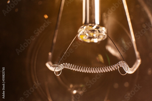 Tungsten filament in incandescent lamp, macro close-up