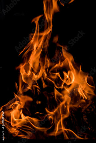 Fire flames on a black background. Blaze fire flame texture background. Close up of fire flames isolated on black background. Burn. Abstract fire flames background. Texture. 