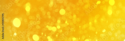 Bright yellow sparkling glitter bokeh background, banner texture. Abstract defocused lights header. Wide screen wallpaper. Panoramic web banner with copy space for design