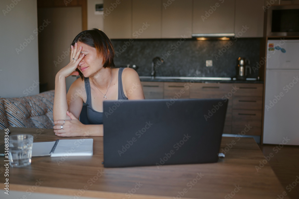 Frustrated sad woman feeling tired, worried about problem sitting at laptop, depressed girl worried about reading bad news online, debt notification email or negative message Frustrated sad woman feeling tired, worried about problem sitting at laptop, depressed girl worried about reading bad news online, debt notification email or negative message