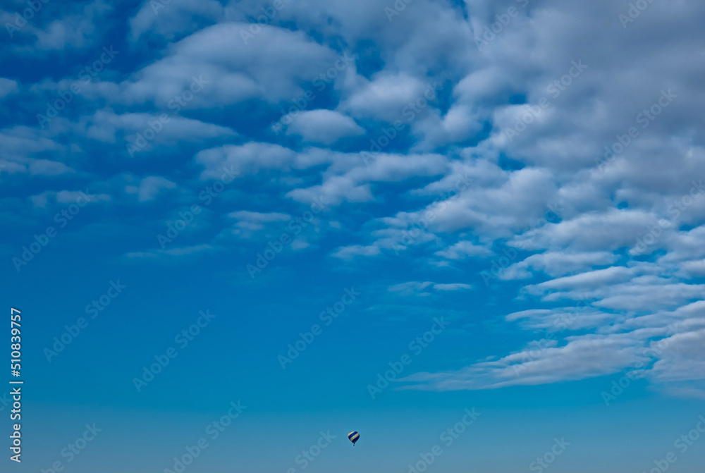 Air balloon in the distance on a background of blue sky Air balloon in the distance on a background of blue sky