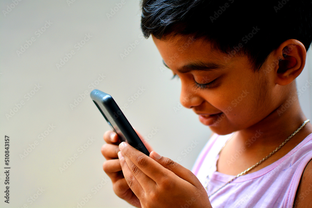 Close up of a little boy holding a smartphone. Close up of a little boy holding a smartphone.