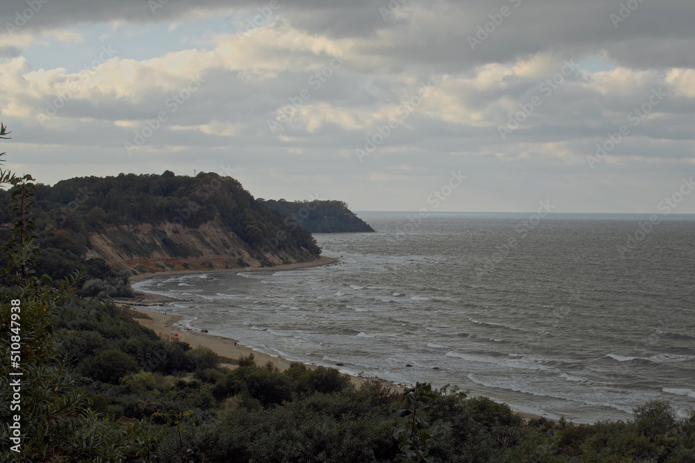 Top view shot, overlooking at Philins bay on a cloudy cold day, in Kaliningrad area, Russia. Panoramic view of cliffs surrounding a bay of water on a cloudy day