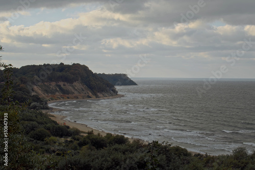 Top view shot, overlooking at Philins bay on a cloudy cold day, in Kaliningrad area, Russia. Panoramic view of cliffs surrounding a bay of water on a cloudy day