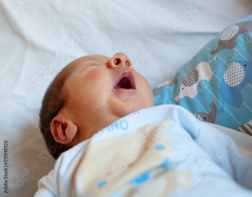Detail of the mouth of a newborn while yawning. Selective focus on the mouth to accentuate the concept of the meaning of the yawn.