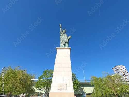 PARIS  FRANCE - APRIL  16  2022 The Replica Of The Famous Statue Of Liberty On The Ile Aux Cygnes  Seine River  Paris. This Statue Was Given In 1889 To France By U.S. Citizens Living In Paris 
