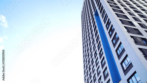 Bottom view of new residential high-rise buildings with blue sky. Urban environment. Frame. Newest residential complexes with an eco-friendly environment