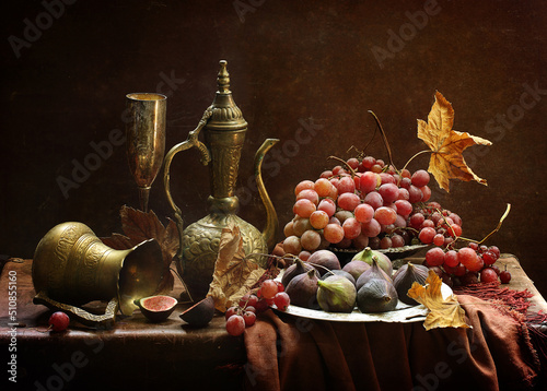 Kumgan with figs and grapes on a wooden table photo