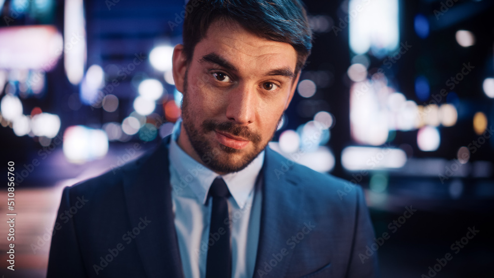 Portrait of Handsome Bearded Man Smiling, Looking at Camera, Standing in Night City with Bokeh Neon Street Lights in Background. Happy Confident Young Man Wearing Stylish Suit. Portrait of Handsome Bearded Man Smiling, Looking at Camera, Standing in Night City with Bokeh Neon Street Lights in Background. Happy Confident Young Man Wearing Stylish Suit.