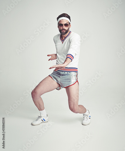 MagicianTennisian. Nobody talks bad to him. A young man in the studio wearing retro sportswear and shades.