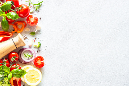 Fresh vegetables, herbs and spices on white background. Ingredients for healthy cooking. TFlat lay with copy space.