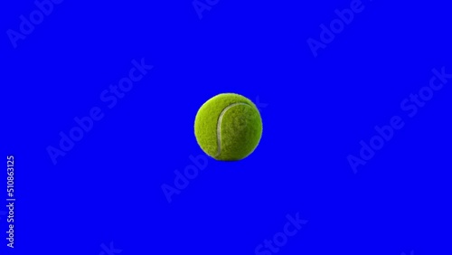 Side on view of a 3D tennis ball rolling across the screen. Standard yellow and green tennis ball in a continuous spin perfect for sports advertising. Footage with a blue screen for isolating the ball