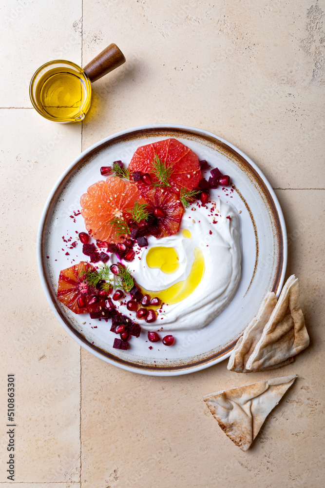 Labneh middle eastern lebanese cream cheese dip. Labneh with grapefruit,  roasted beetroot, pomegranate, fennel, sumac.