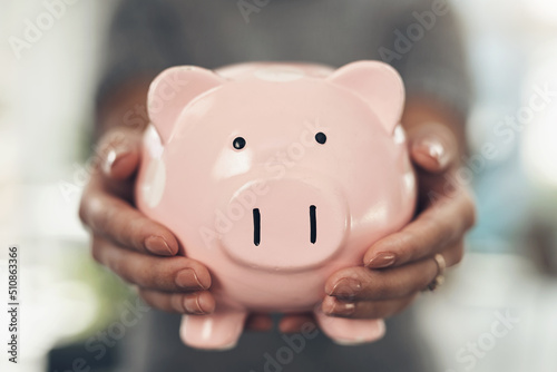 Save for your goals and dreams. Closeup shot of an unrecognisable businesswoman holding a piggybank.