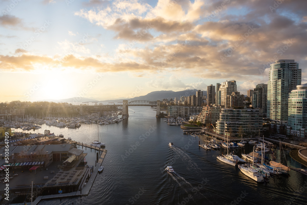 Aerial View of Granville Island in False Creek with modern city skyline and mountains in background. Downtown Vancouver, British Columbia, Canada. Sunset Sky Art Render