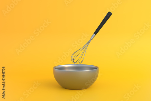Fotografie Metal bowl with whisk for preparation of dough on yellow background