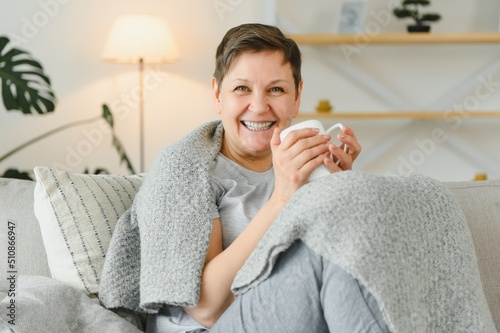 great looking middle aged woman having a calm morning and enjoying her coffee. photo