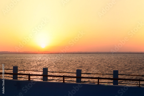 Sunset Over The Tropical Sea or Sunset over the arabian Sea. Bright Orange Sun Setting on Beautiful Blue Water. located in Diu district of Union Territory Daman and Diu Gujarat India.