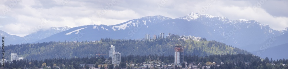 Modern City, Burnaby Mountains and Landscape in Background. Vancouver, British Columbia, Canada.