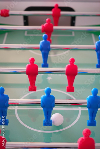 Close up of foosball Table Soccer Game match figures. Football Kicker Game with blue and red figurines.