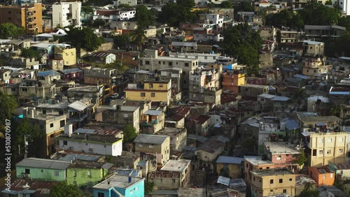 The urban outskirts of the capital of the Dominican Republic with dirty streets and dilapidated houses. Settlement of disadvantaged citizens with low social security. Ill-conceived urbanization. photo