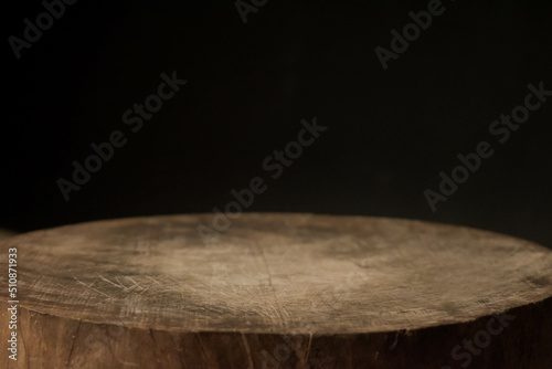 empty wooden round cutting board on black background use to place object