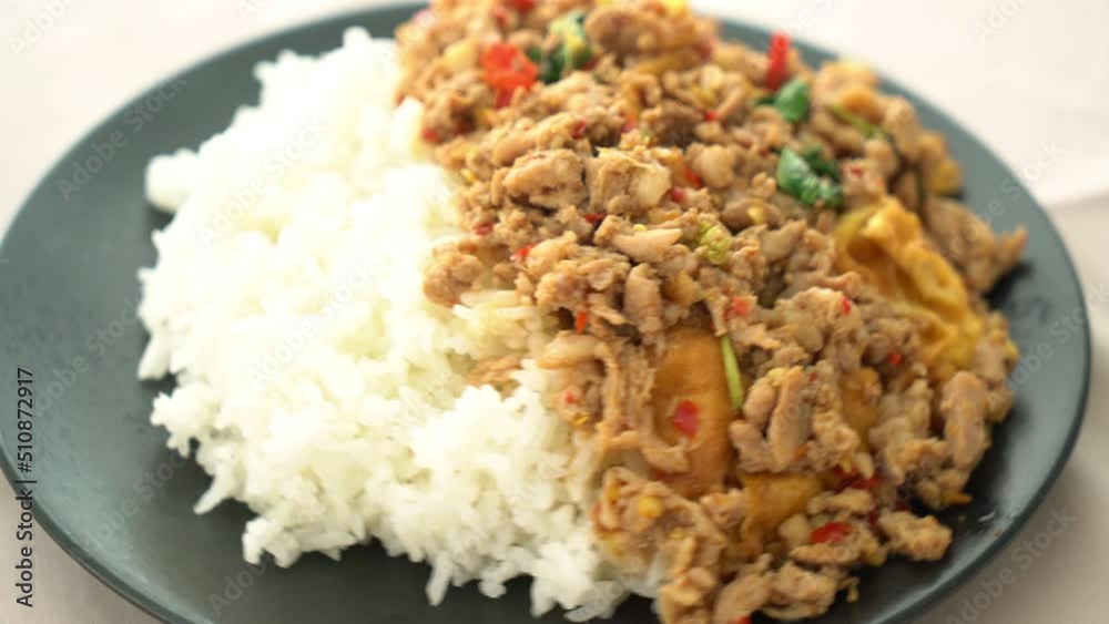 stir-fried minced pork with basil and egg topped on rice - Asian food style stir-fried minced pork with basil and egg topped on rice - Asian food style