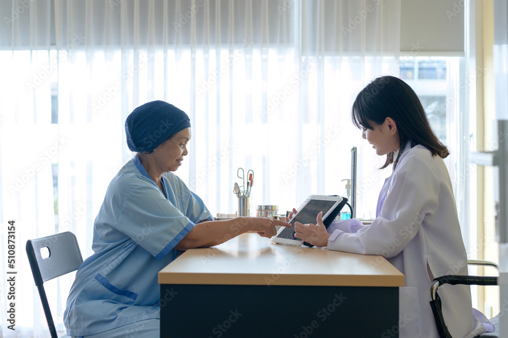 Cancer patient woman wearing head scarf after chemotherapy consulting and visiting doctor in hospital.... Cancer patient woman wearing head scarf after chemotherapy consulting and visiting doctor in hospital....