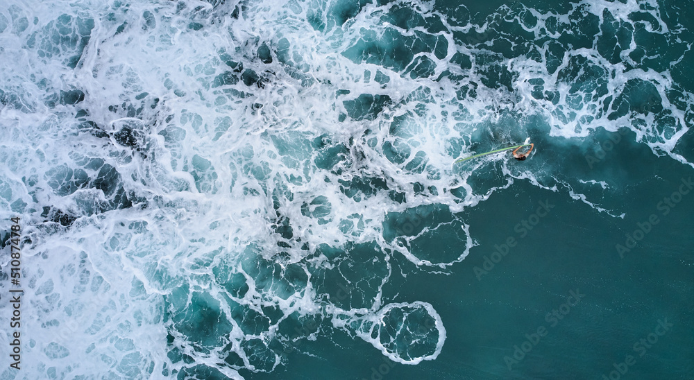 Fototapeta premium Aerial view of the ocean and surfer girl. Surfing in Midigama. Sri Lanka