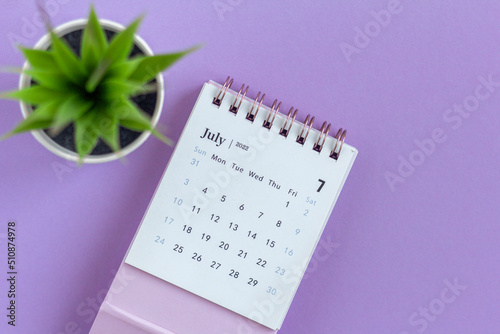 Desktop calendar for July 2022 on a lilac background.,