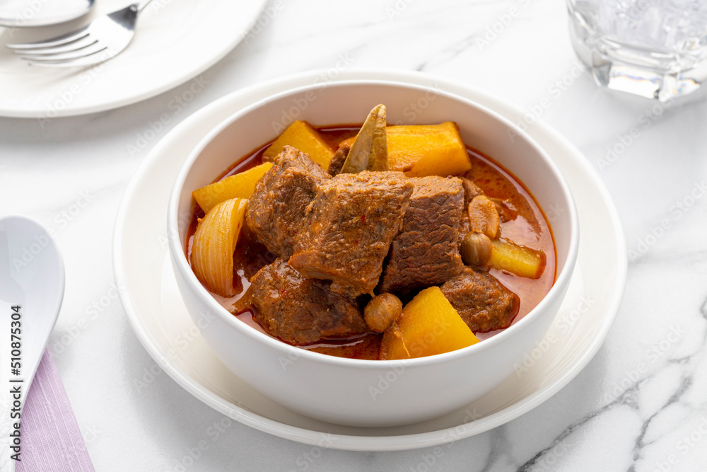 Thai beef massaman curry, one of the most popular Thailand’s signature gourmet dishes popularly served in Thai restaurants, in authentic Thai cooking style. Thai beef massaman curry, one of the most popular Thailand’s signature gourmet dishes popularly served in Thai restaurants, in authentic Thai cooking style.