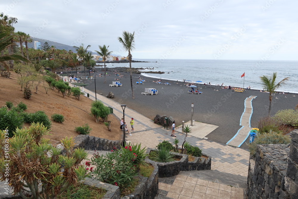 Jardin beach, Puerto de la Cruz, Tenerife, Spain, May 27, 2022: The quiet Jardin beach with volcanic black sand and manicured gardens on the Atlantic ocean, Puerto de la Cruz, Tenerife, Spain