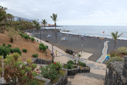Jardin beach, Puerto de la Cruz, Tenerife, Spain, May 27, 2022: The quiet Jardin beach with volcanic black sand and manicured gardens on the Atlantic ocean, Puerto de la Cruz, Tenerife, Spain