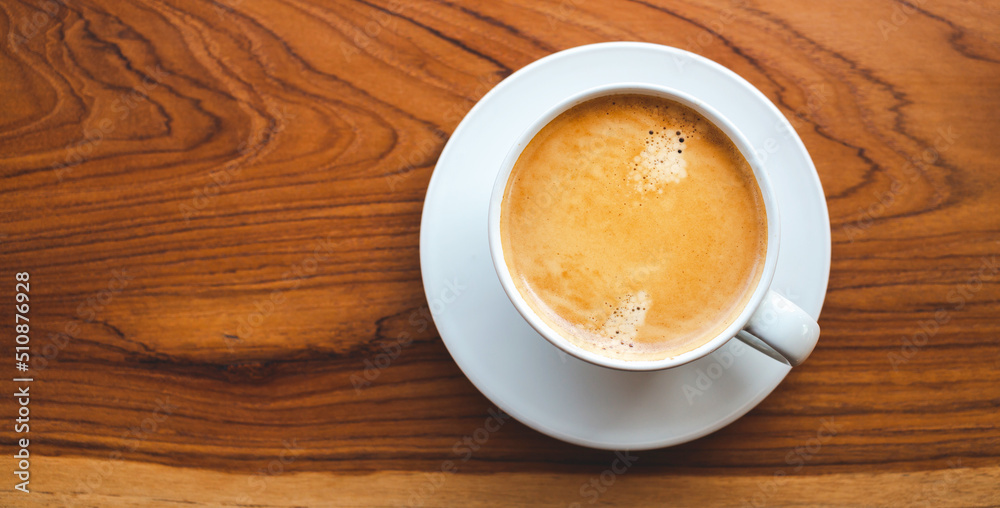 Top view of coffee cup with foam on wooden table.close-up Top view of coffee cup with foam on wooden table.close-up