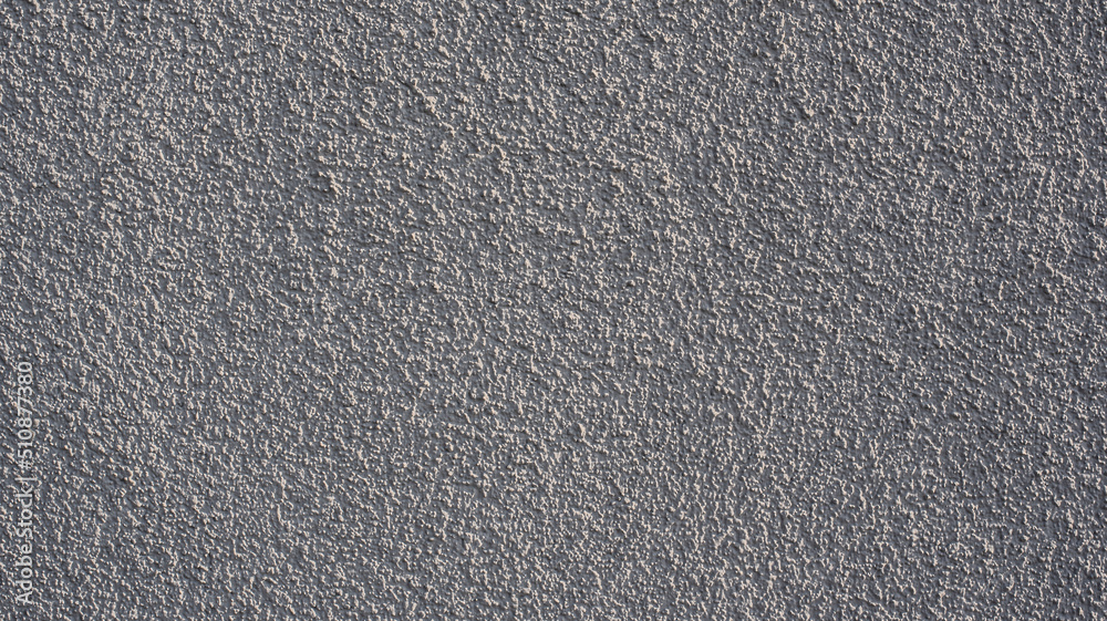Obraz premium a gray painted wall with rough plaster