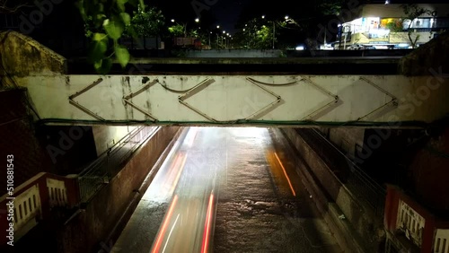 Chennai, India - June 4th 2022: Hyper-lapse view of chennai city busy night rush hour traffic in Duraisam Subway, West Mambalam. Busy traffic and vehicle crossing time lapse. Long Exposure Video. photo