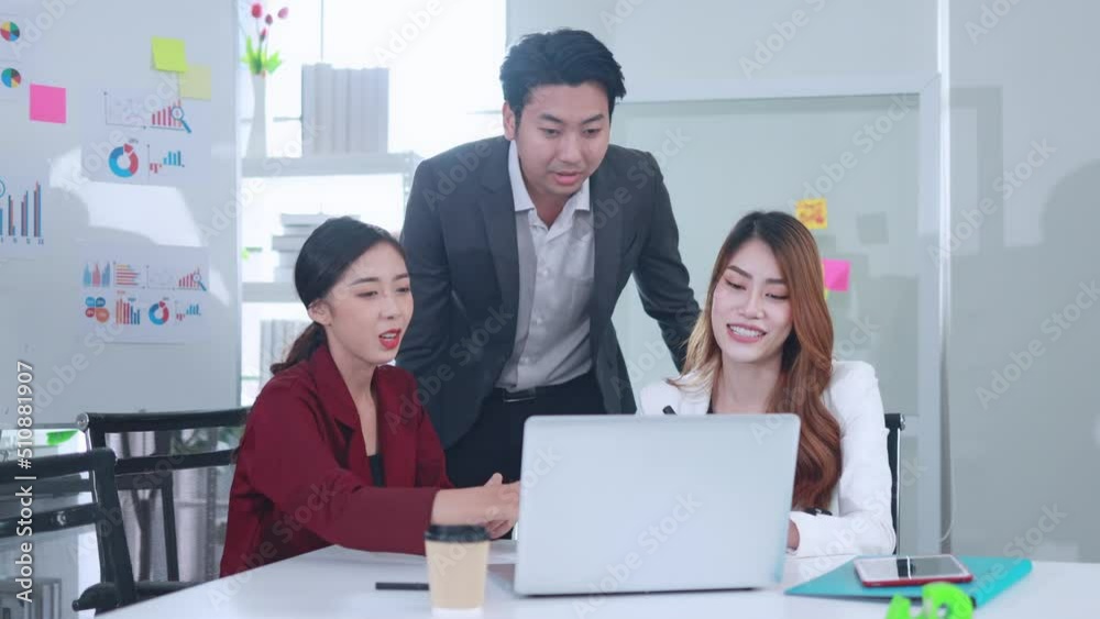 Young Asian express joy in the successful teamwork of the business in the office.