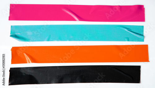 Set of pink, blue, orange, black tapes on white background. Torn horizontal and different size sticky tape, adhesive pieces. photo