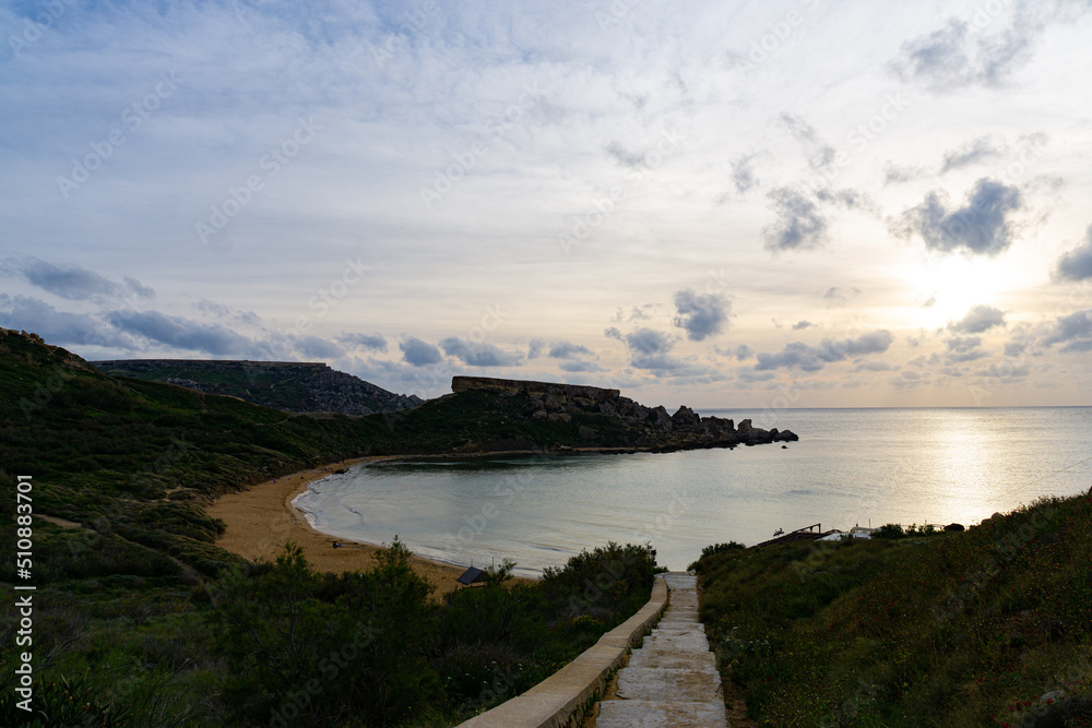 Beautiful sunset with clouds and a calm sea in Malta.
