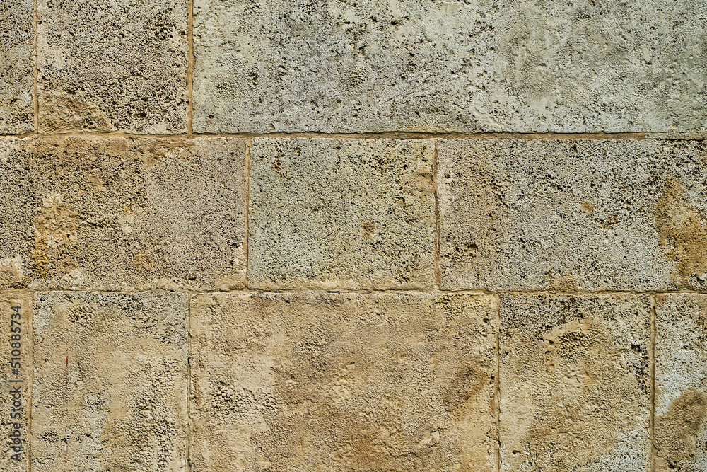 Fototapeta premium Background of old stone wall of sandstone house, interior decoration or design idea