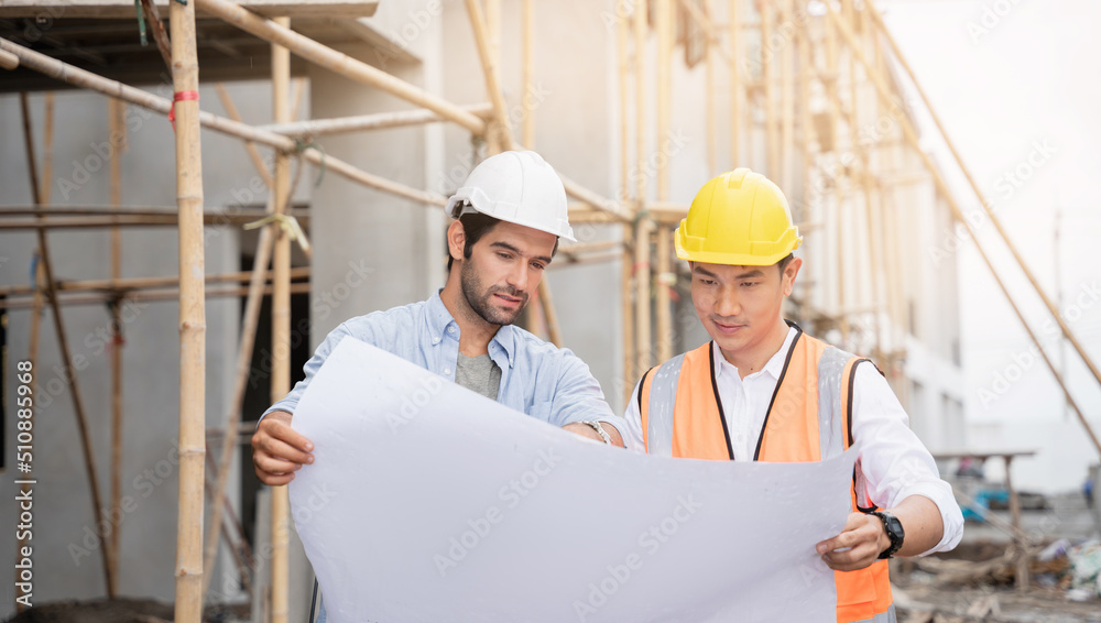 The engineer manager and foremen discussed the site projects on the construction site to check the various functions. The engineer manager and foremen discussed the site projects on the construction site to check the various functions.
