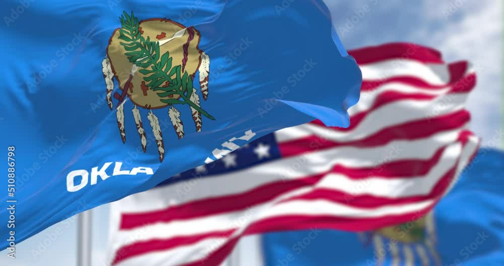 The Oklahoma state flag waving along with the national flag of the US