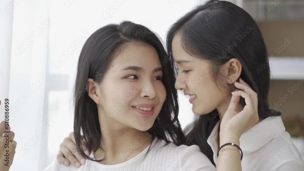 LGBTQ lesbian and homosexual women hold hands and look into each other's eyes with love. happy smile Transgender couples. Couple Equality, LGBTQ+ Concept LGBTQ lesbian and homosexual women hold hands and look into each other's eyes with love. happy smile Transgender couples. Couple Equality, LGBTQ+ Concept