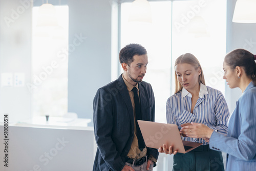 Woman discussing data with colleagues in meeting.