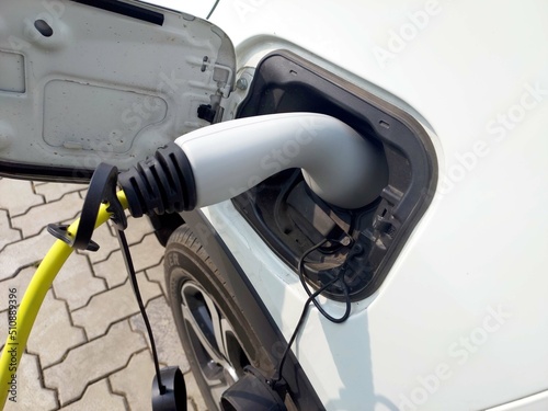 charging connect to electric car on charge station, Electric mobility environment friendly