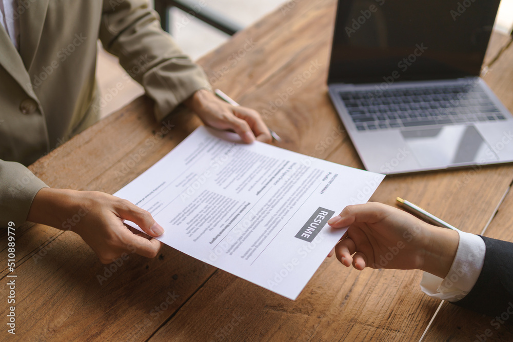Close-up of business owner check resume of job applicants in company at the office. Close-up of business owner check resume of job applicants in company at the office.