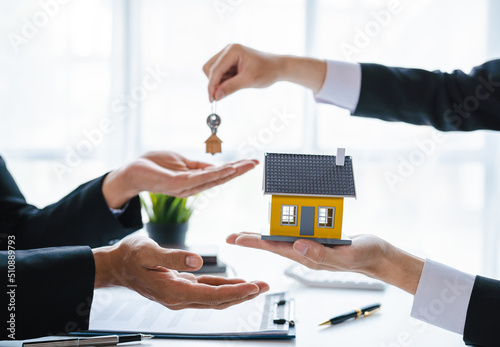 real estate agent The sales manager hands the customer the keys after signing the leasing contract. About Offering Mortgage Loans and Home Insurance