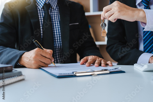real estate agent The sales manager hands the customer the keys after signing the leasing contract. About Offering Mortgage Loans and Home Insurance
